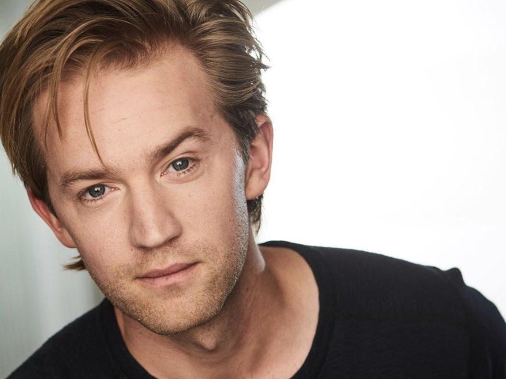 Jason Dolley looking into the camera while wearing a black tee shirt.