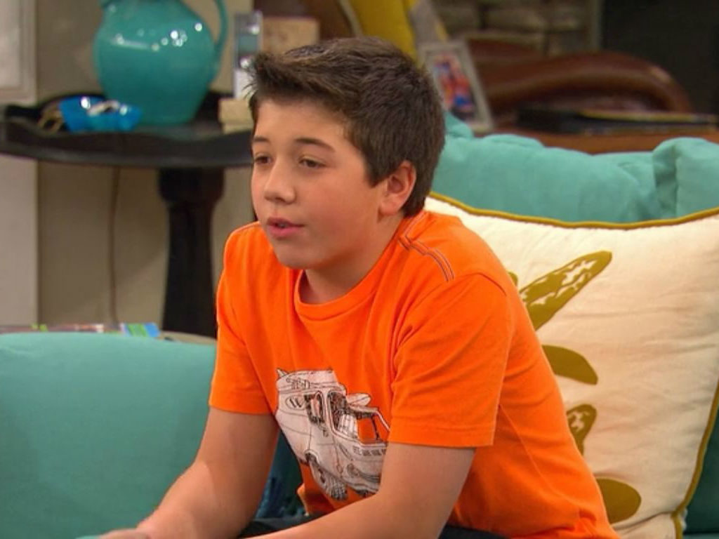 Bradley Steven Perry sitting on a couch while filming an episode of "Good Luck Charlie."