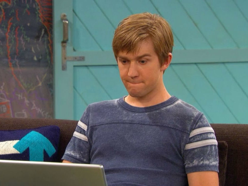 Jason Dolley looking at a laptop screen while filming an episode of "Good Luck Charlie."