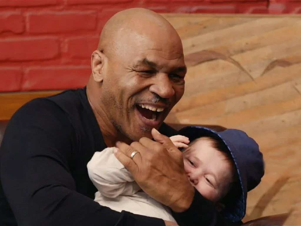 Hasbulla being held by Mike Tyson.