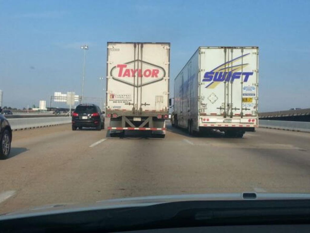 A truck that reads "Taylor" next to a truck that reads "Swift"