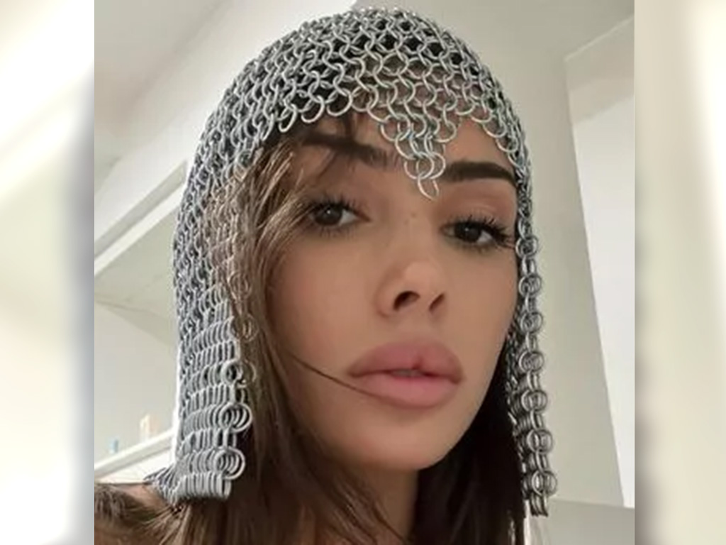 Bianca Censori wearing chainmail on her head in a selfie