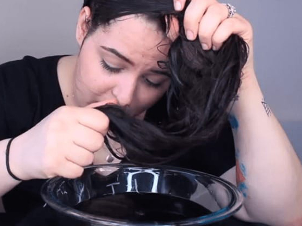 Woman washing her hair with Coca-Cola