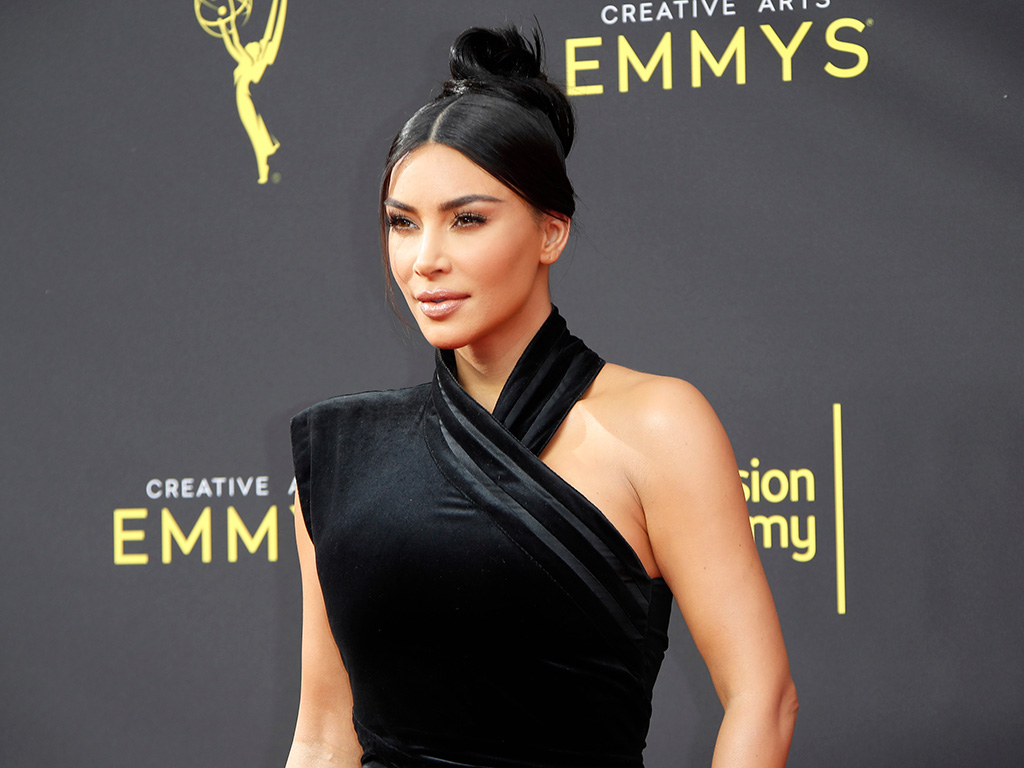 Kim Kardashian wearing a black gown on the Emmy's red carpet