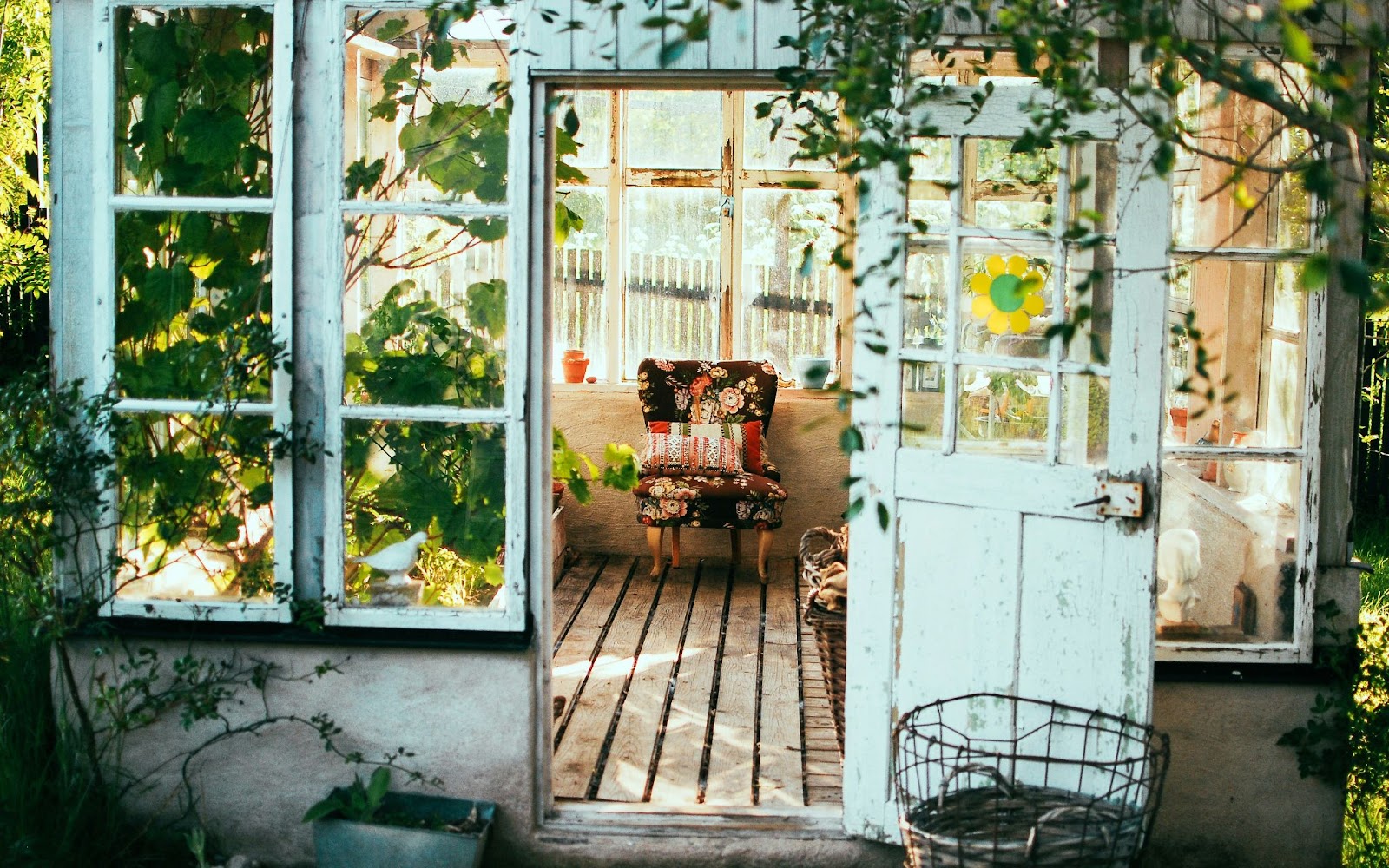 A home with an old chair in it, made out of wood with door open