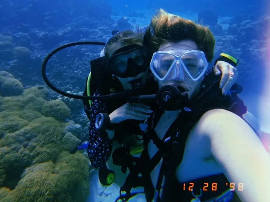 Millie Bobby Brown and Jake Bongiovi underwater during a dive.