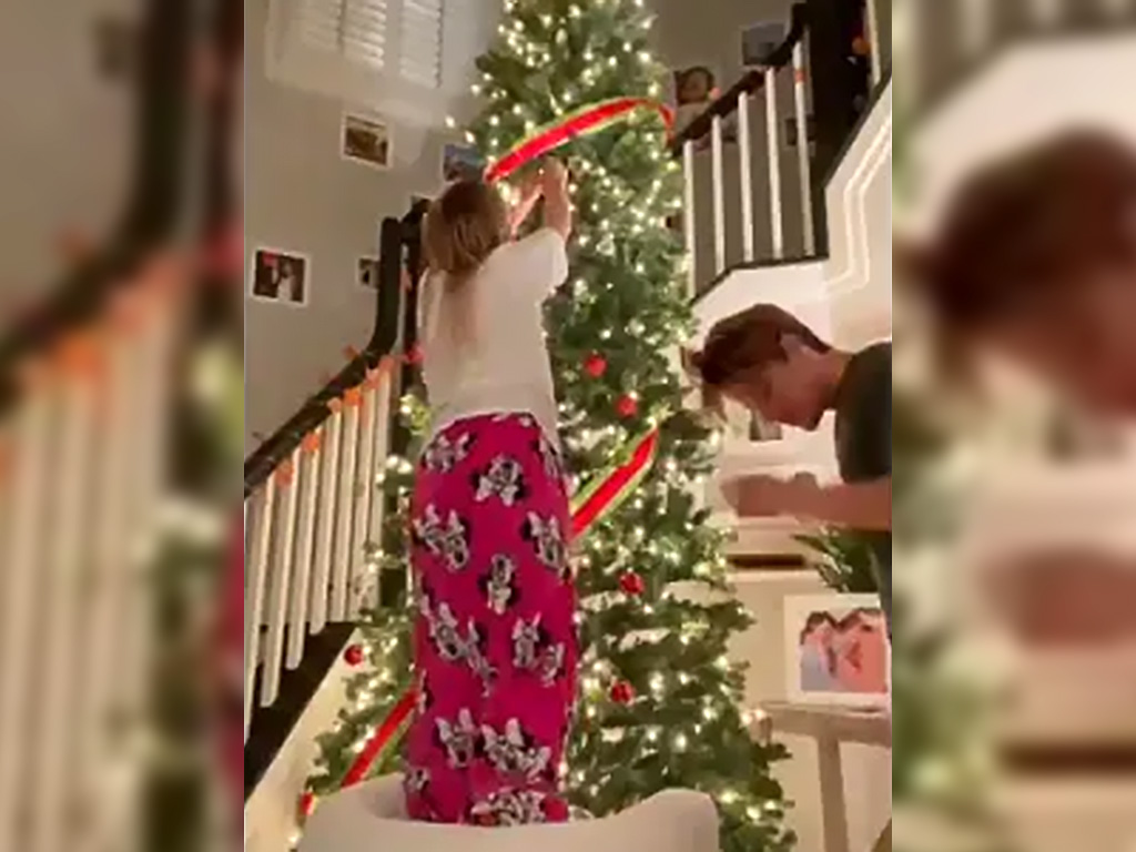 Millie Bobby Brown decorating a Christmas tree in her home