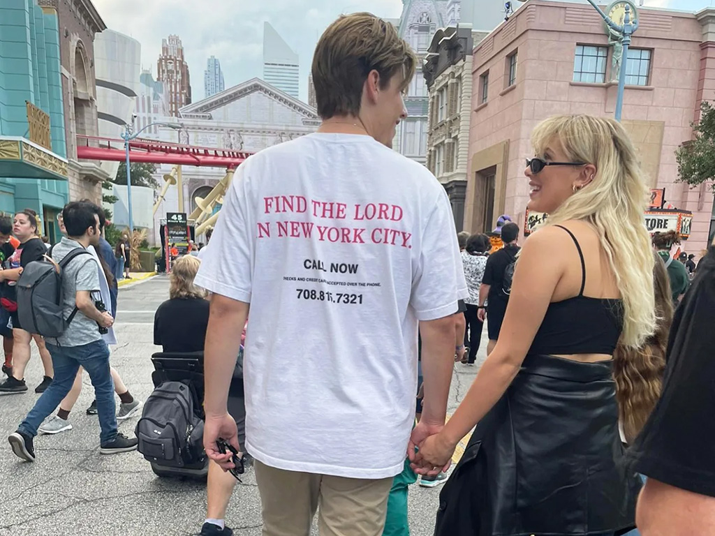 Millie Bobby Brown and Jake Bongiovi walking down a city street while holding hands