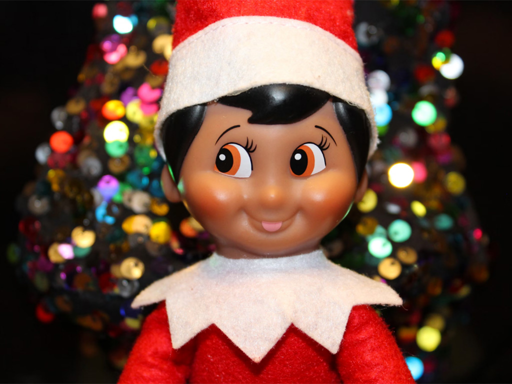 A Christmas elf doll smiling 