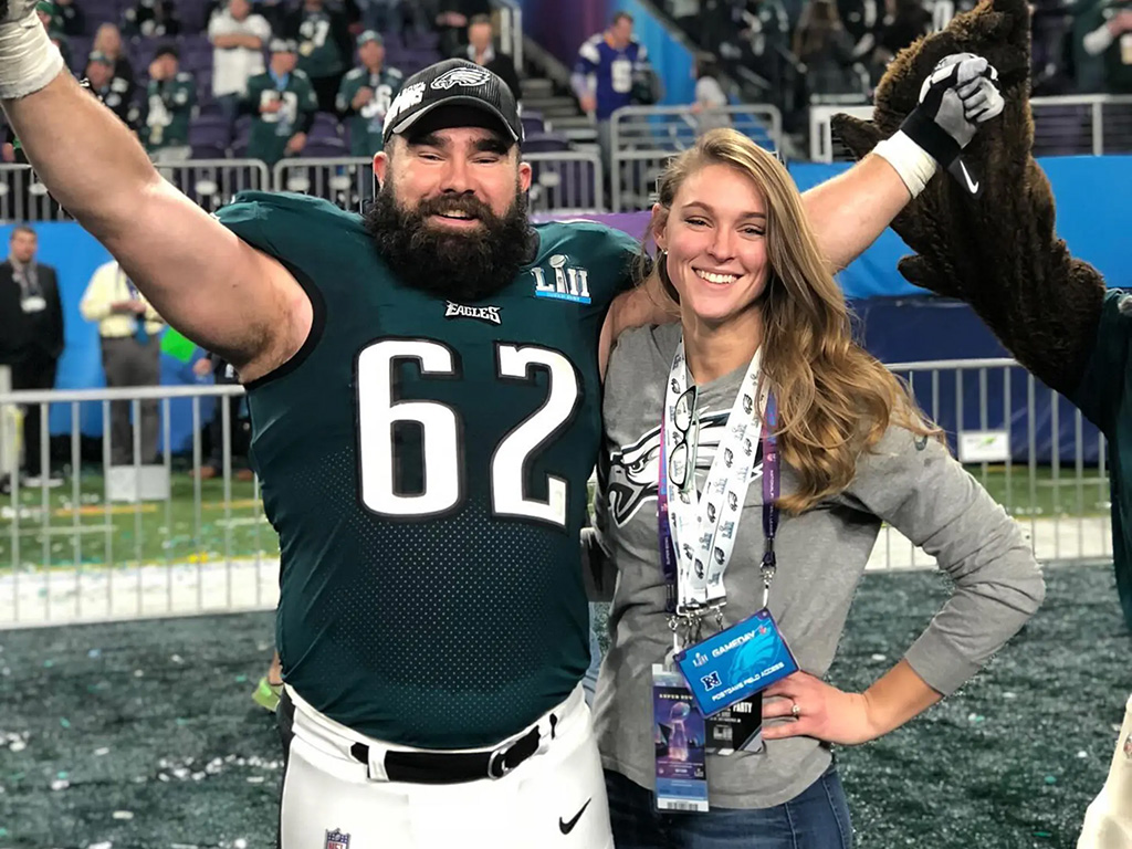 Kylie Kelce and her husband Jason Kelce celebrating on the football field