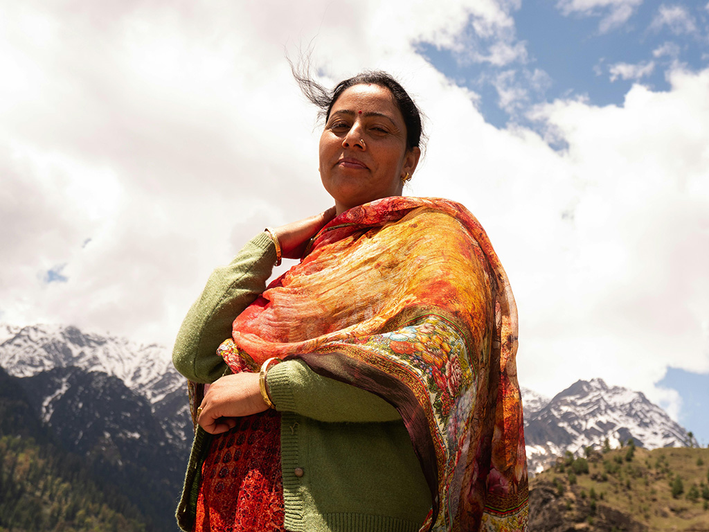 Positive ethnic female resting in village near mountains