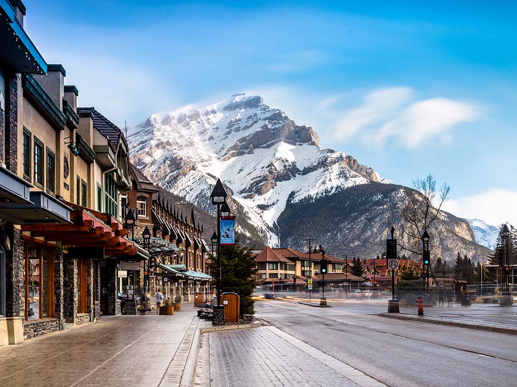 View of a busy street at Banff city Canada during transition season from winter to snow