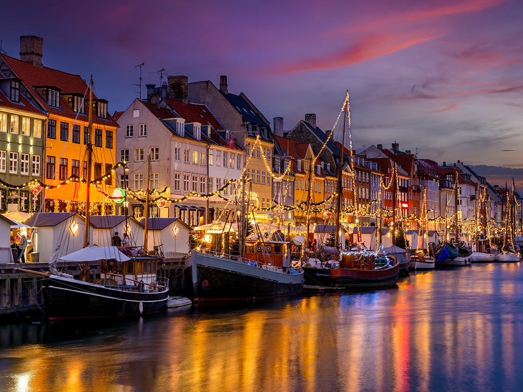 Beautiful winter sunset view of the popular Nyhavn area at Copenhagen, Denmark, decorated for Christmas