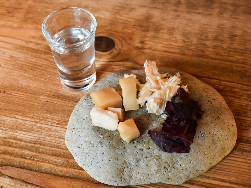 An Icelandic meal of fermented shark, or Hákarl, a culinary adventure from Iceland, showcases fermented shark meat with a distinct aroma and robust flavor. 