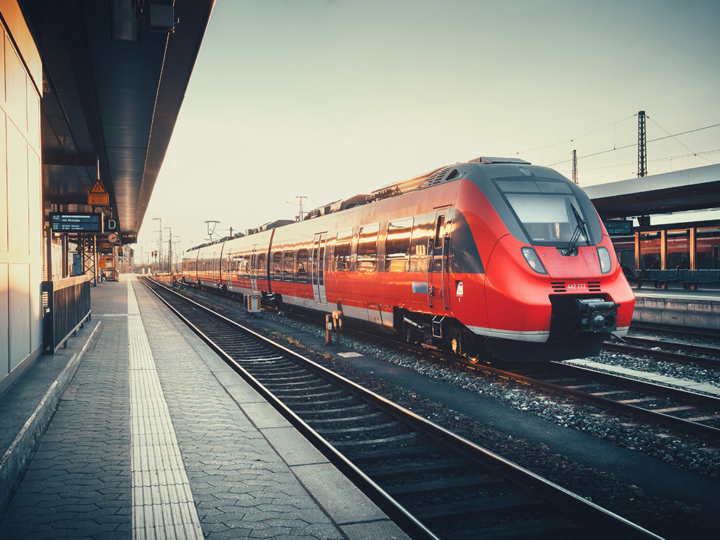 A red metro train pulling into the station