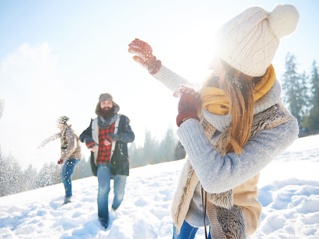 Young couple in snowball fight