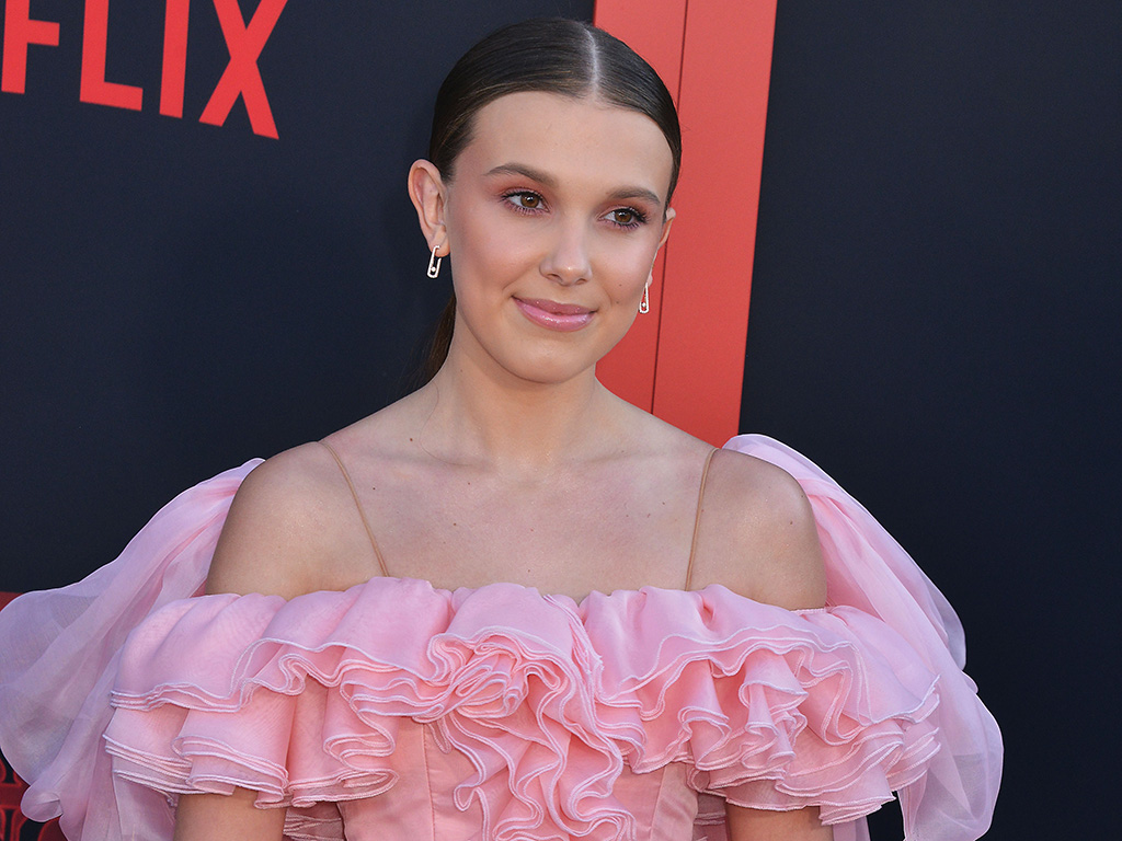 Millie Bobby Brown in a pink dress at a Netflix event