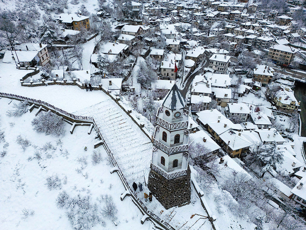 Goynuk - Bolu - Turkey, January 28, 2024, The Victory Tower (Zafer Kulesi) with the traditional houses in the background.