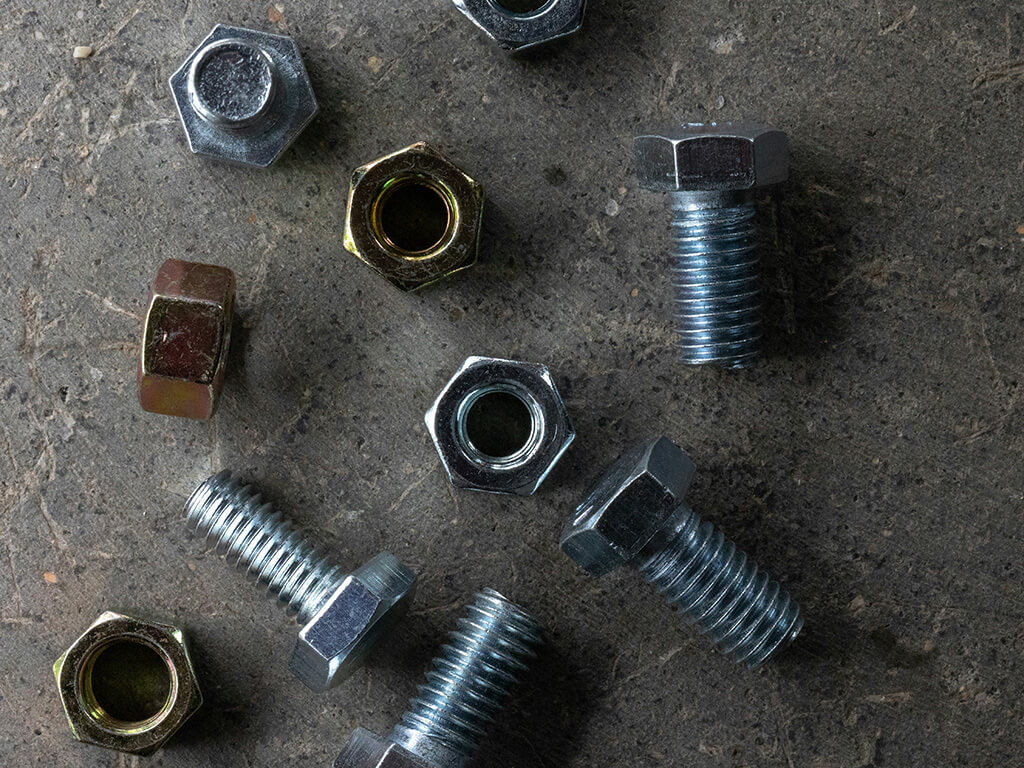 A bunch of nuts and bolts laying on the ground