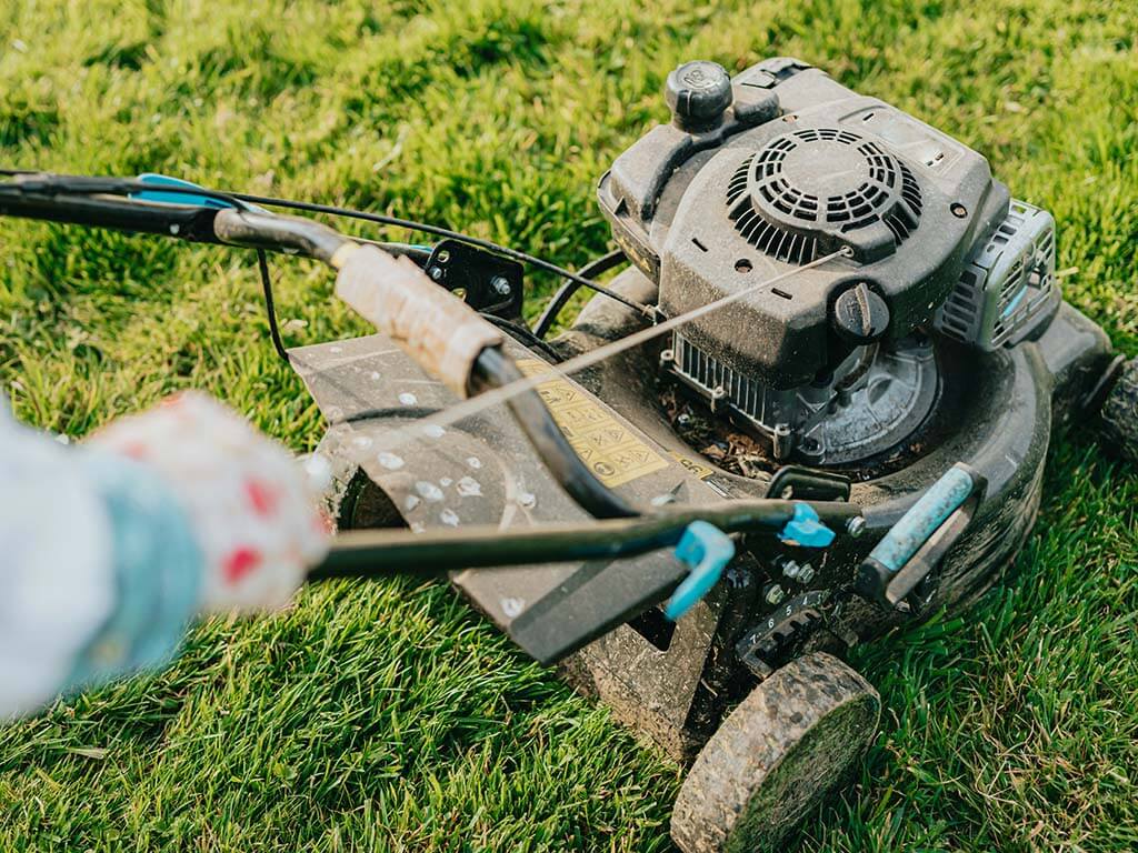 Lawn mower on a lush field 