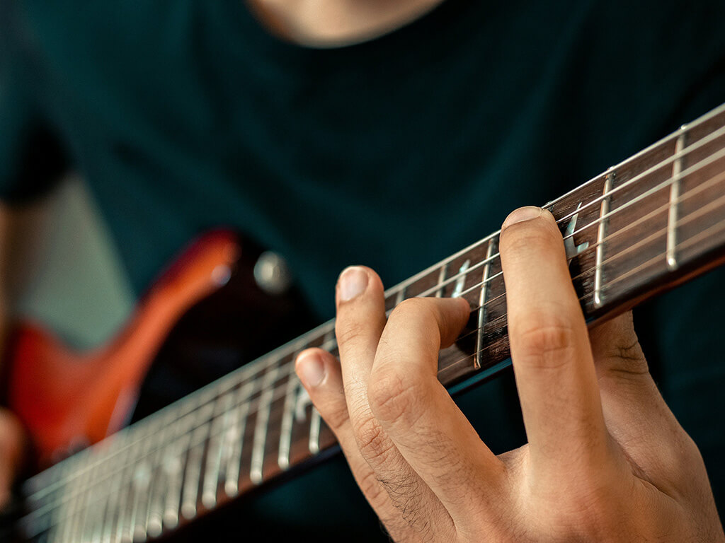 Person playing guitar in close up 