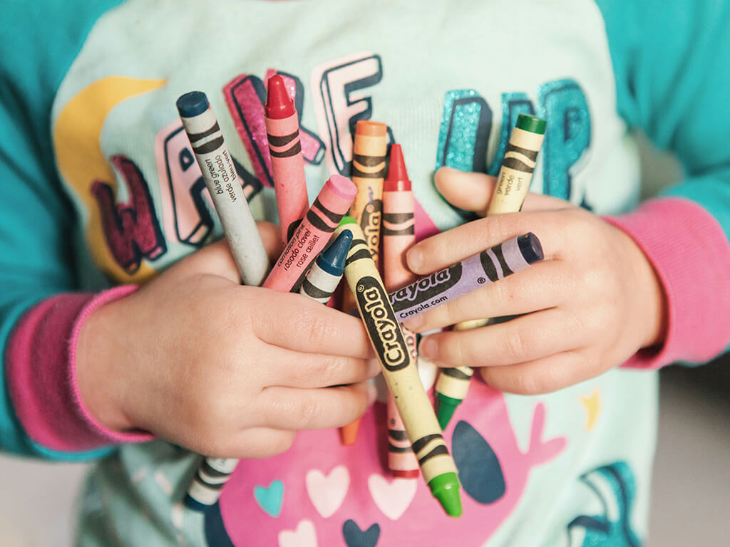 Child holding crayons