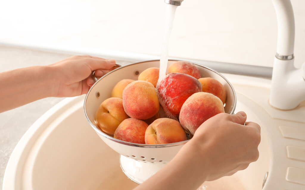 Washing peaches in the sink