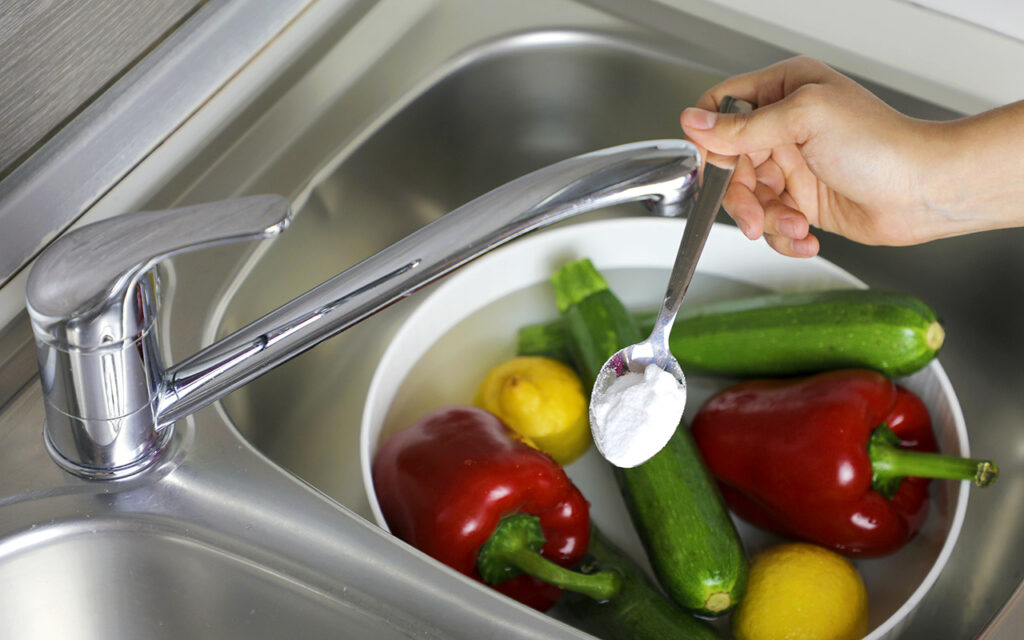 Sprinkling baking soda on vegetables 