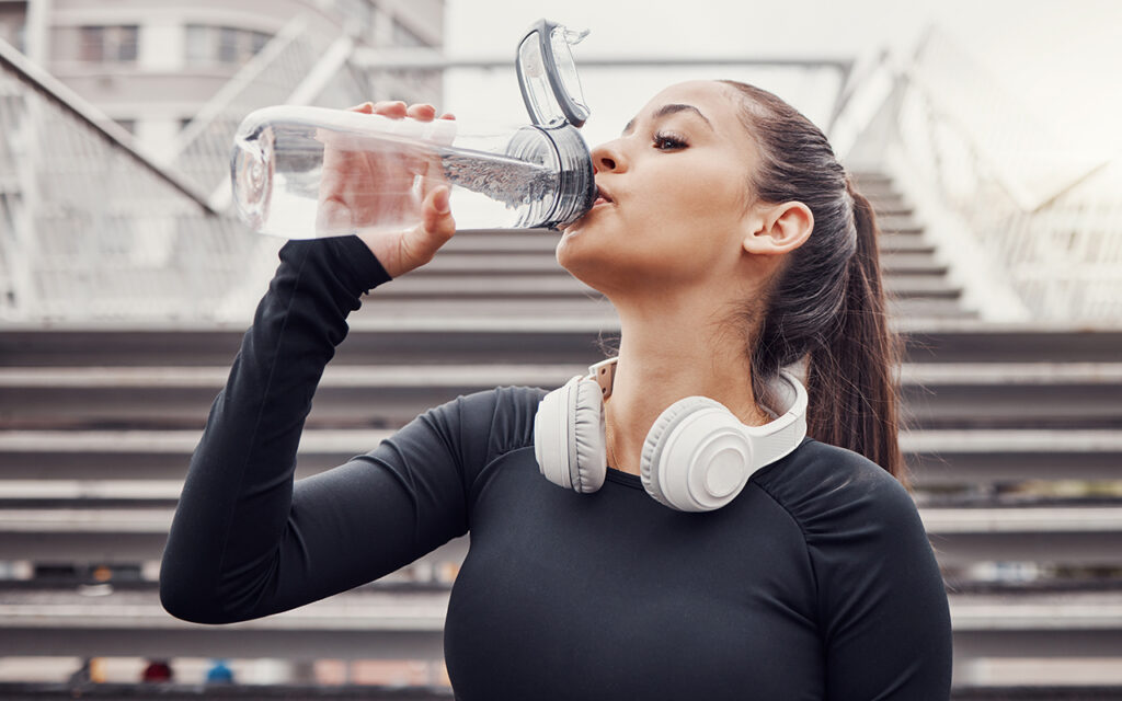 Woman drinking water while working out