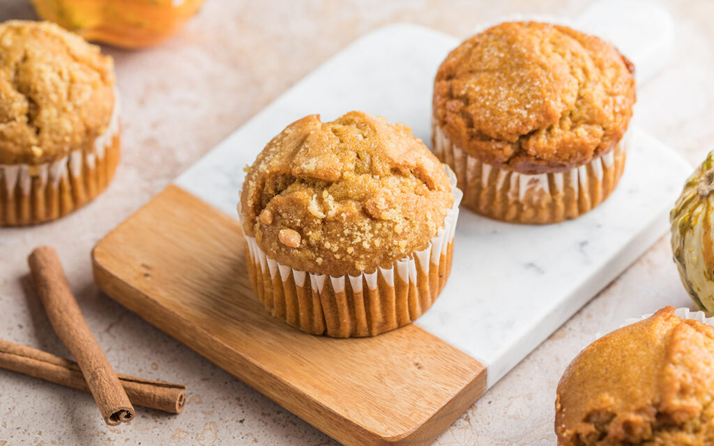 Pumpkin muffins next to cinnamon sticks