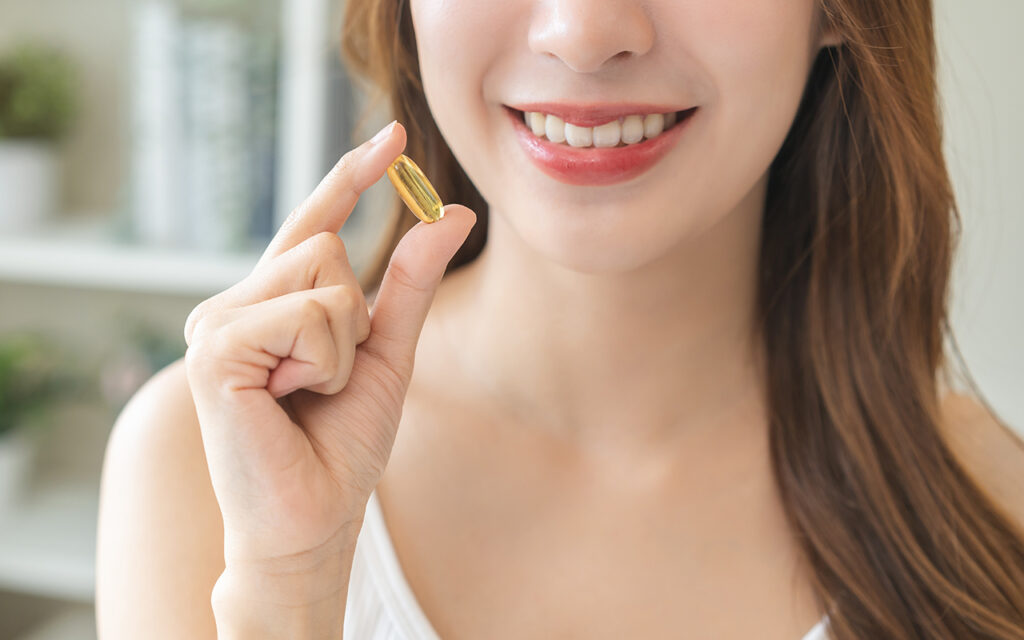 Woman taking vitamin D supplement