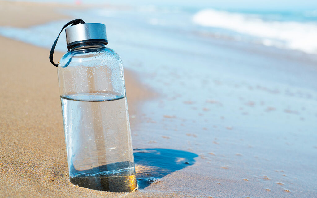 Water bottle on the beach