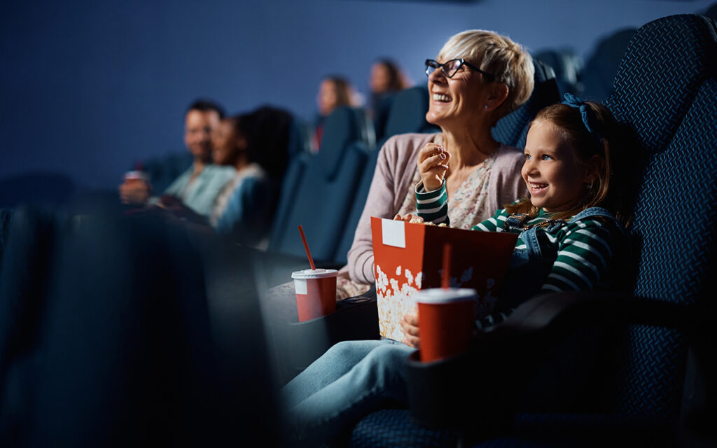 Grandma and granddaughter at a movie theatre 